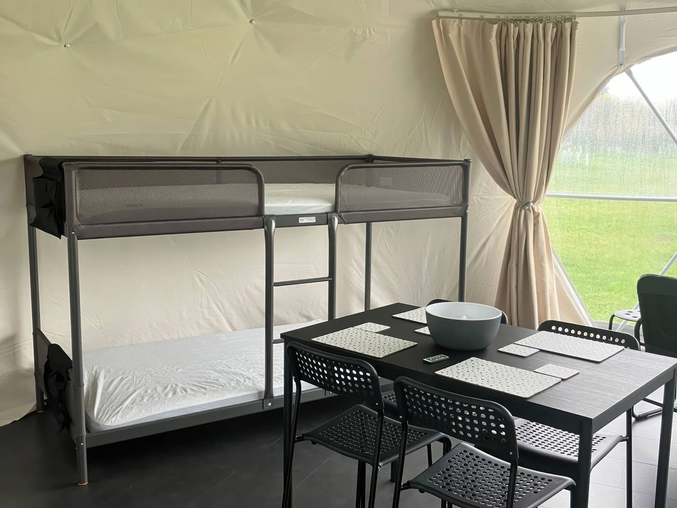 A bunk bed and a dining table with chairs at Sherwood - Geodome, Mansfield