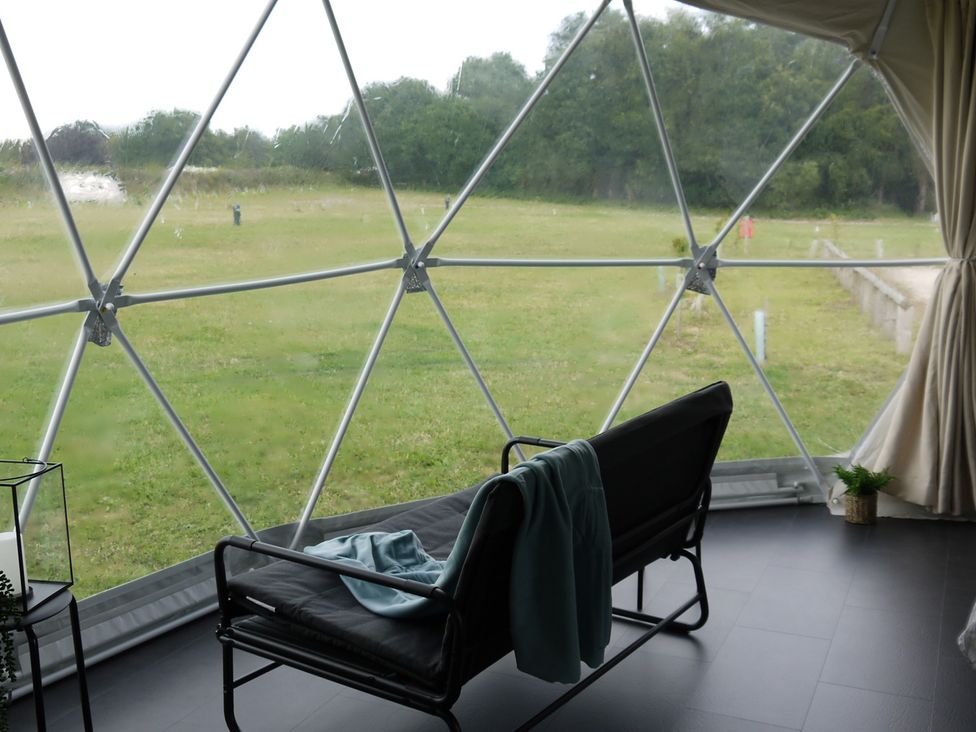 A geodesic dome with a couch and blanket at Sherwood - Geodome in Mansfield