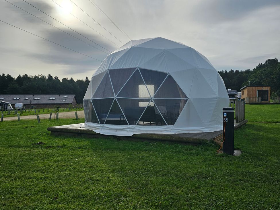 A geodesic dome with a deck in an outdoor area at Sherwood - Geodome, Mansfield