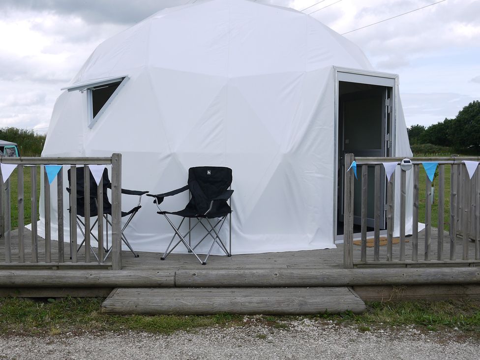 A geodesic dome with chairs on a wooden deck at Sherwood - Geodome in Mansfield