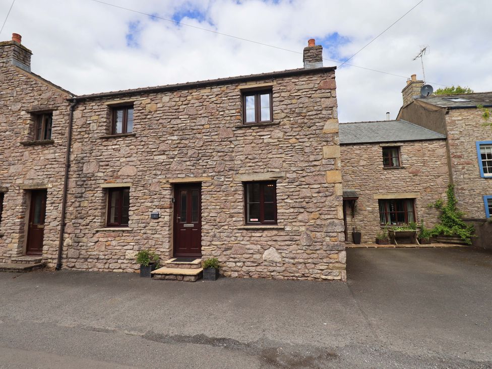 A stone house with windows and a front door at 4 Mellbecks Mews Kirkby Stephen