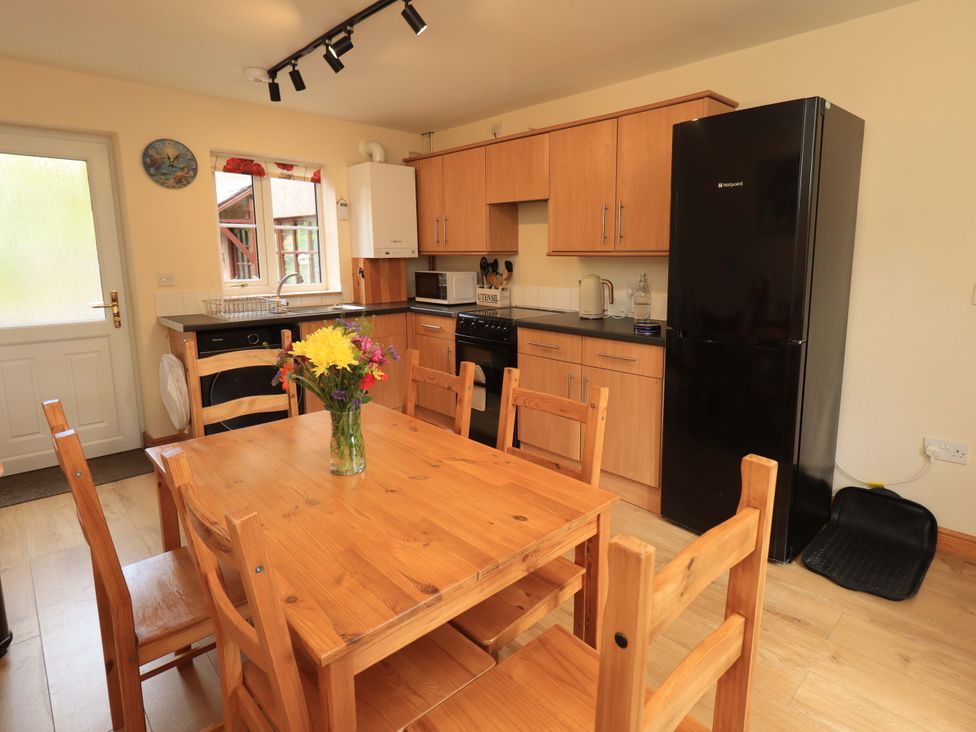 A kitchen with a dining table and chairs at 4 Mellbecks Mews Kirkby Stephen