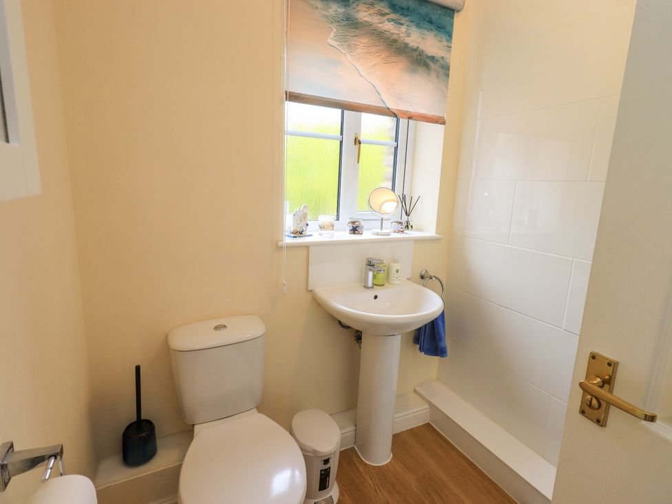 A bathroom with a toilet and sink at 4 Mellbecks Mews in Kirkby Stephen