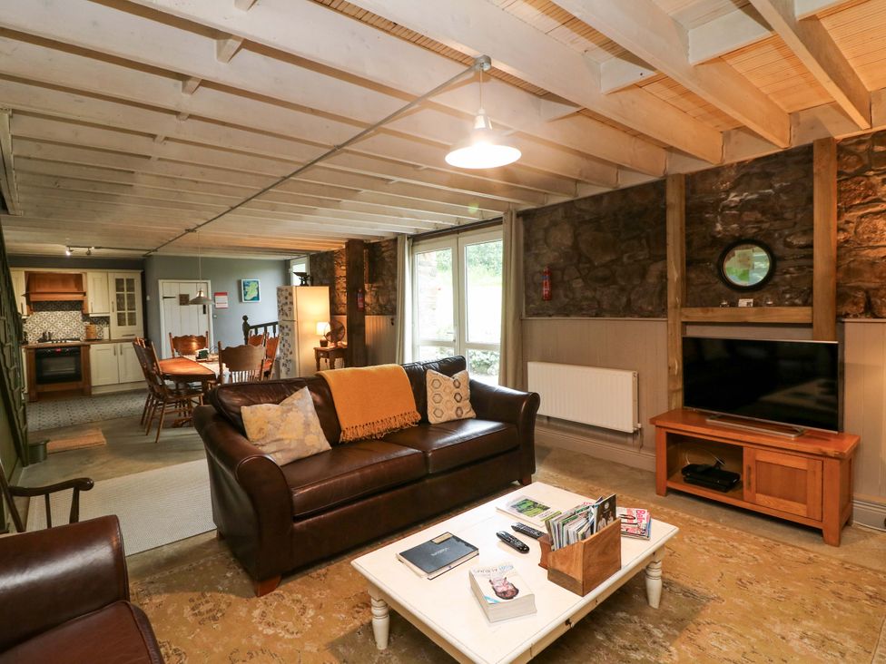 A living room with a sofa and coffee table at Childwall Cottage in TULLOGHER