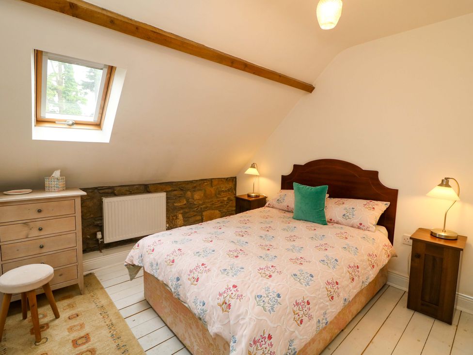 A bedroom with a bed and dresser at Childwall Cottage TULLOGHER