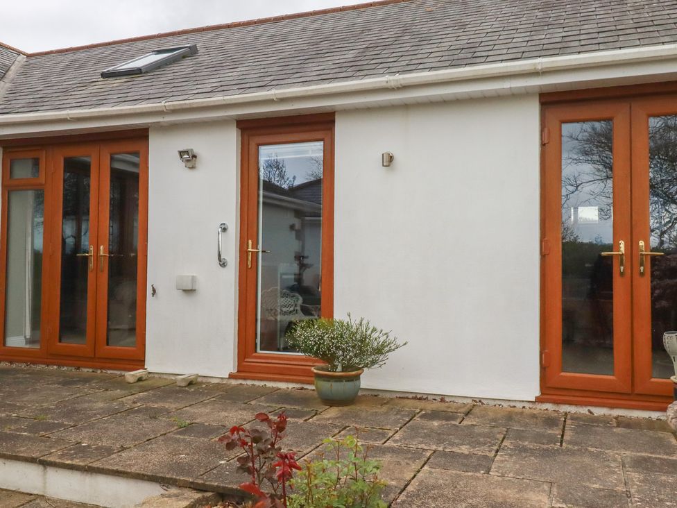 An outdoor area with doors and windows at Honeysuckle Rise in Looe