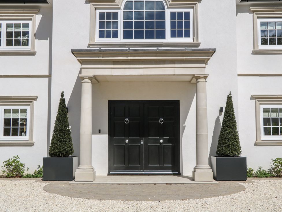 An entrance with a front door and columns at Sea Estate House in Littlehampton