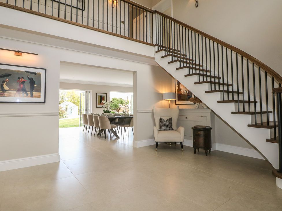 An entryway with a staircase and a dining area at Sea Estate House, Littlehampton