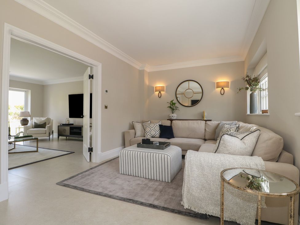 A living room with a couch, coffee table, and decorative accessories at Sea Estate House in Littlehampton