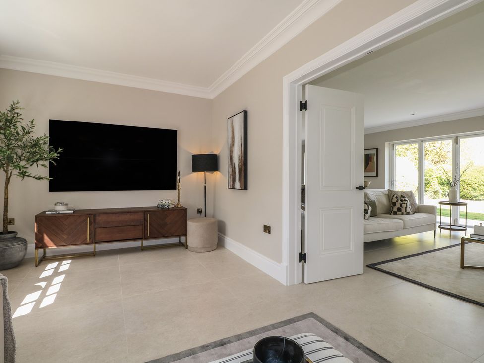 A living room with a TV and sofa at Sea Estate House in Littlehampton