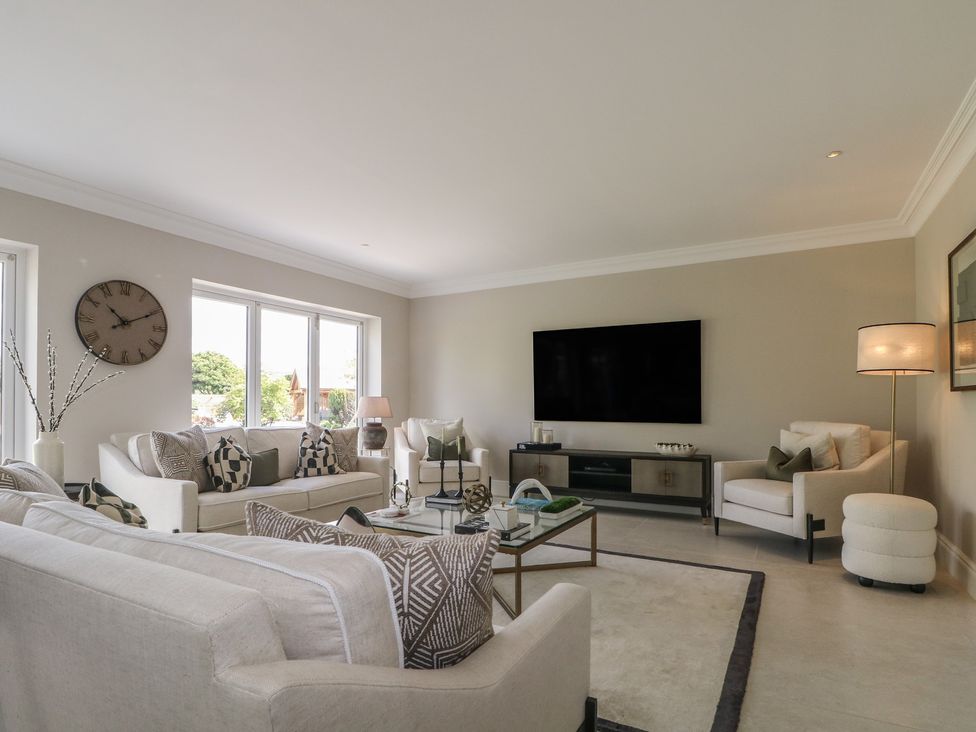 A living room with a television and coffee table at Sea Estate House in Littlehampton
