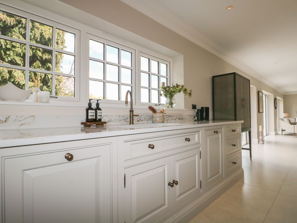 A kitchen with cabinets and countertops at Sea Estate House in Littlehampton