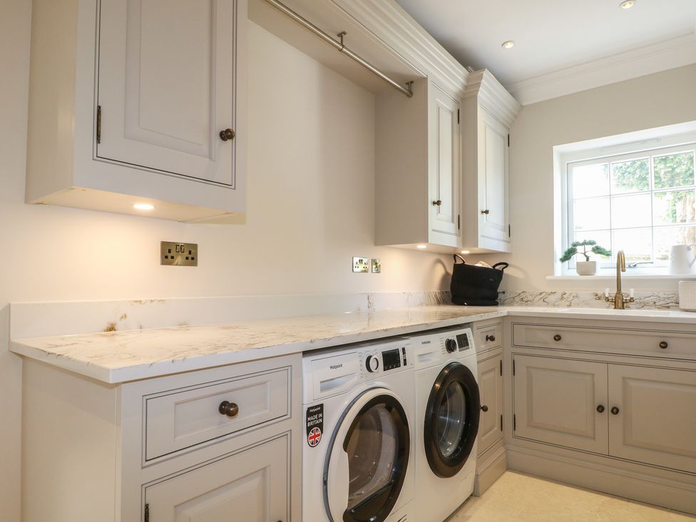 A laundry room with a washing machine and dryer at Sea Estate House in Littlehampton