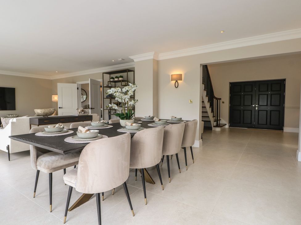 A dining room with a table set for meals at Sea Estate House in Littlehampton