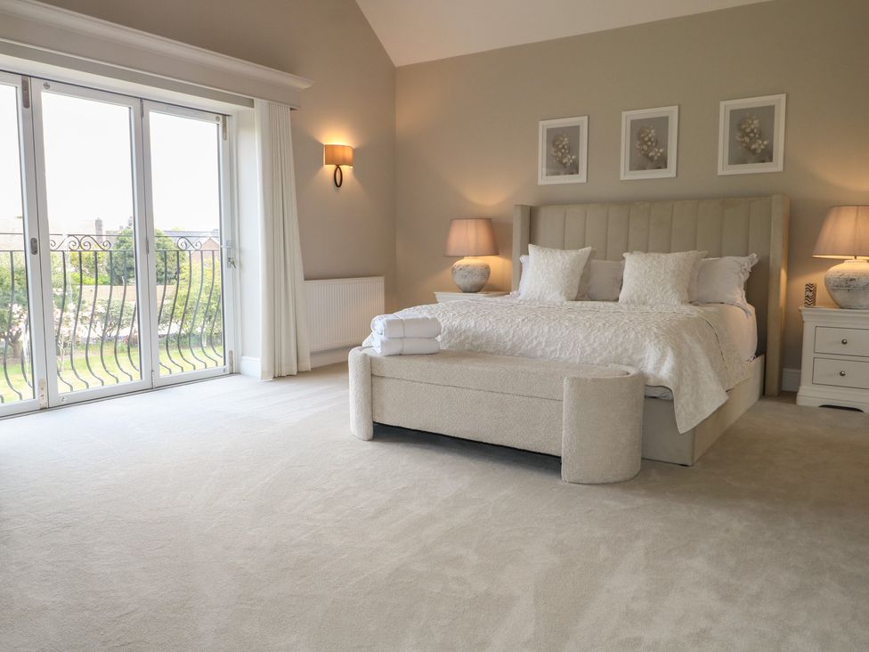 A bedroom with a bed and bedside tables at Sea Estate House in Littlehampton