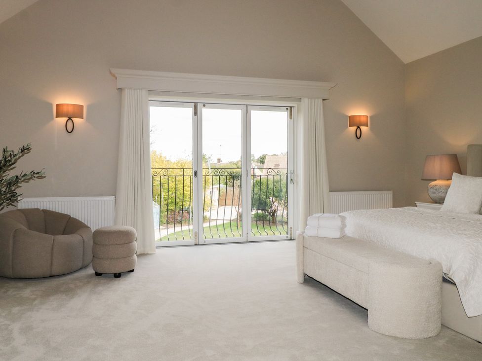 A bedroom with a bed and sliding door at Sea Estate House in Littlehampton