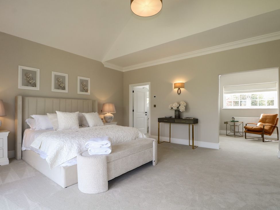 A bedroom with a large bed and side tables at Sea Estate House in Littlehampton