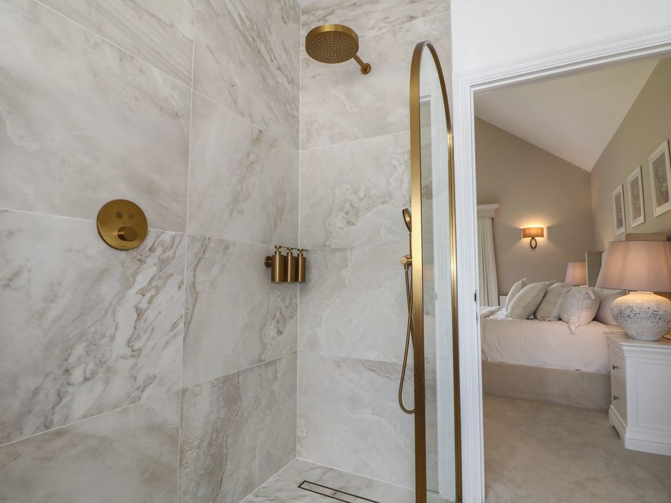A shower area with marble walls at Sea Estate House in Littlehampton