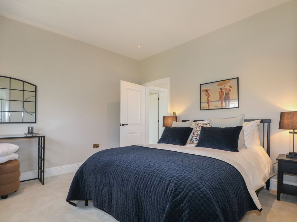 A bedroom with a bed and nightstand at Sea Estate House Littlehampton