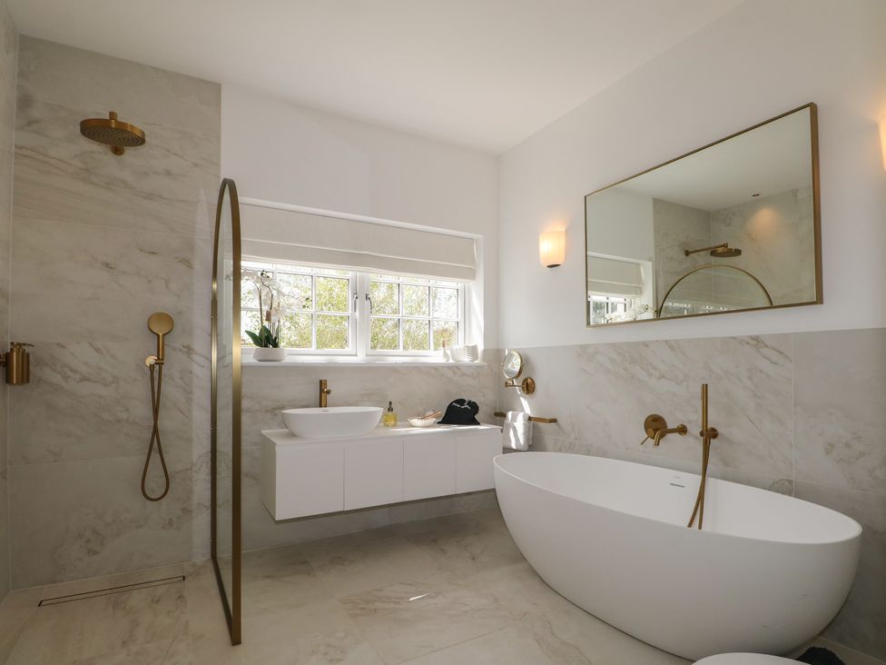 A bathroom with a bathtub and sink at Sea Estate House in Littlehampton
