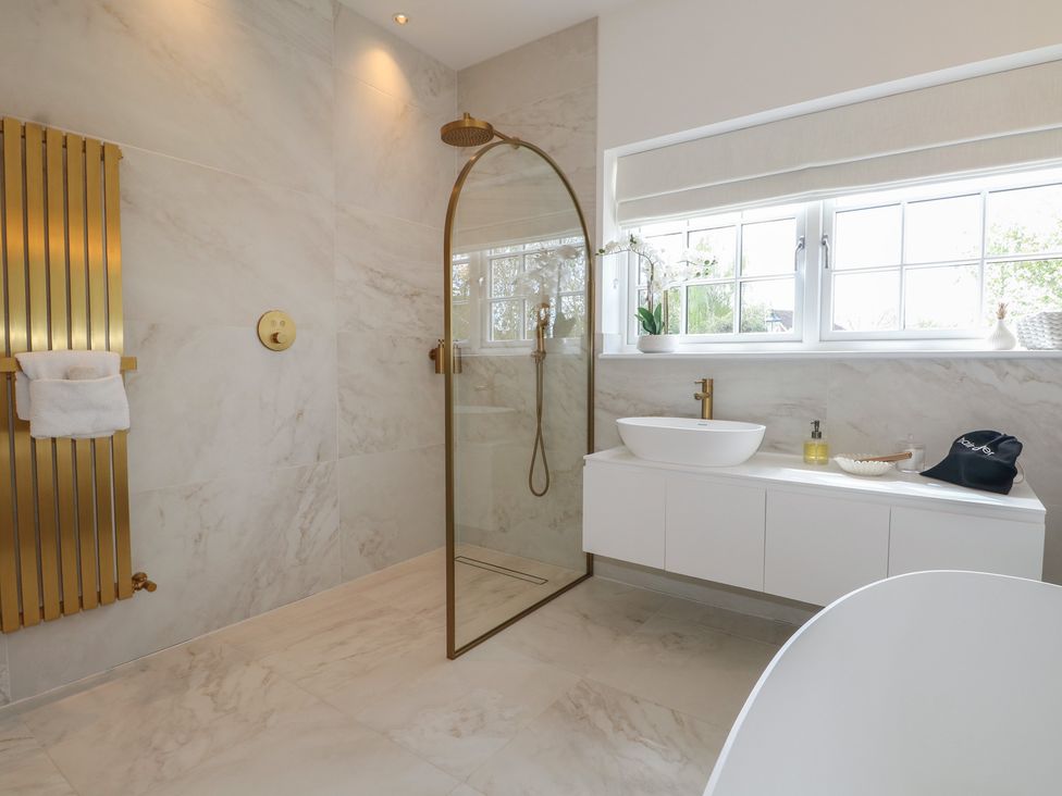 A bathroom with a shower and wash basin at Sea Estate House in Littlehampton