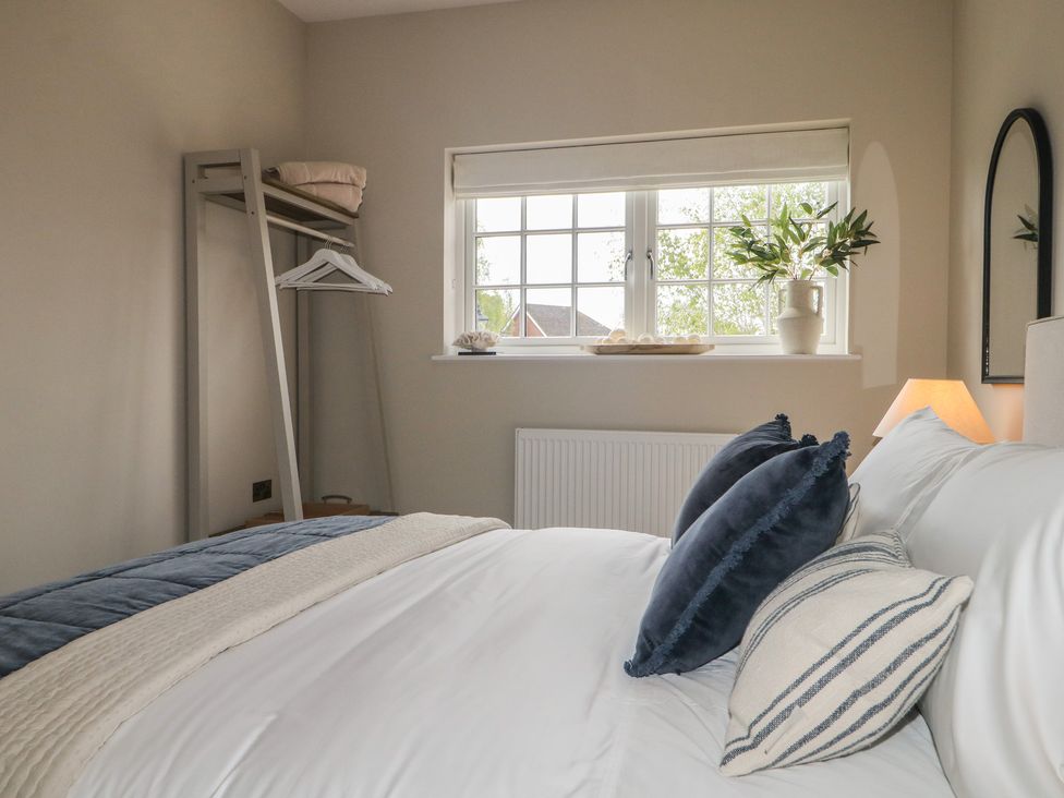 A bedroom with a bed and window at Sea Estate House in Littlehampton