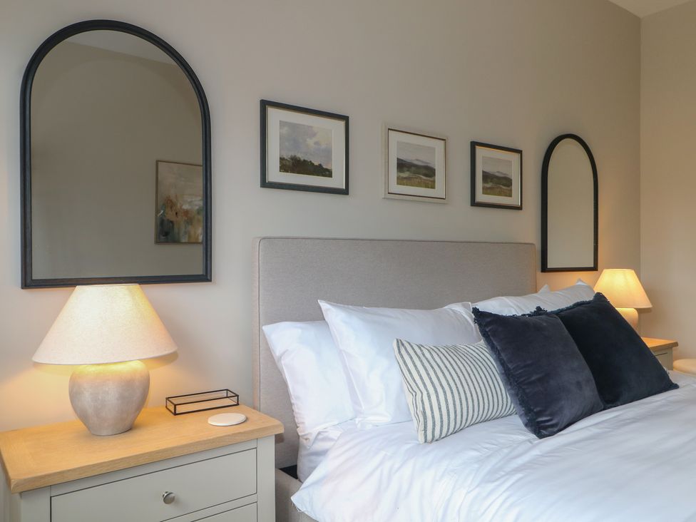 A bedroom with a bed and lamps at Sea Estate House, Littlehampton