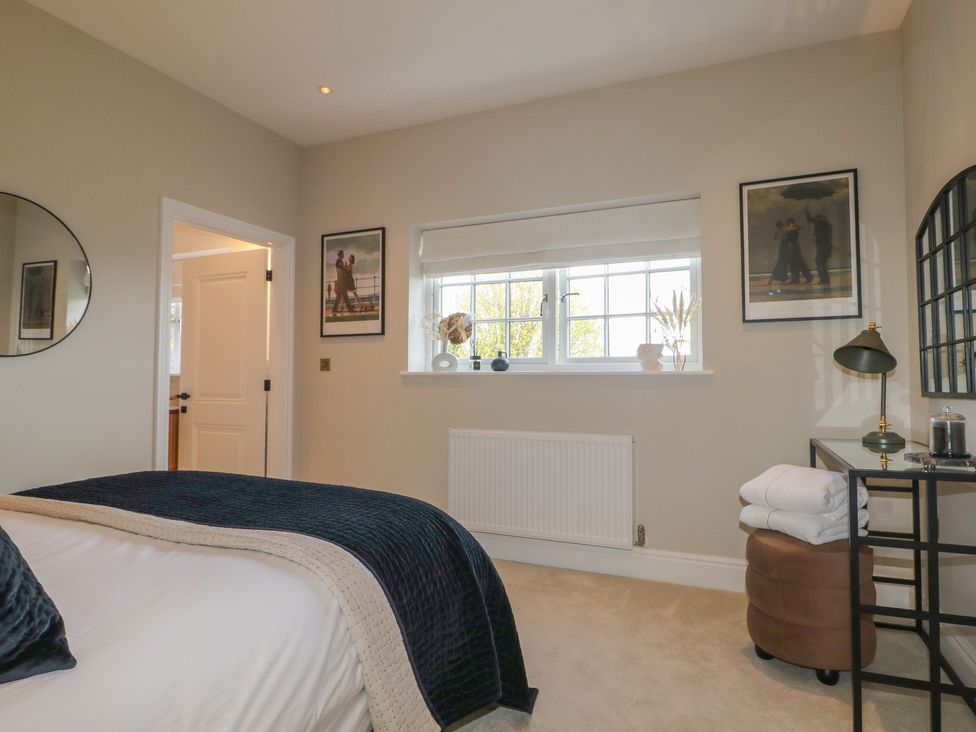 A bedroom with a bed and side table at Sea Estate House in Littlehampton