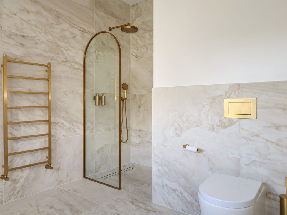 A bathroom with a shower and toilet at Sea Estate House in Littlehampton