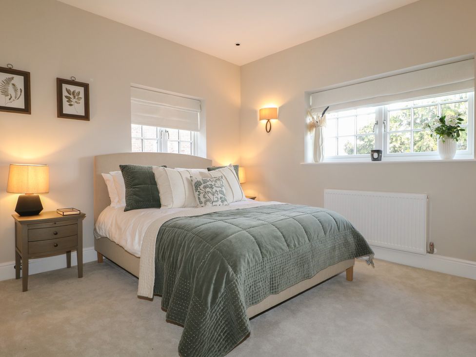 A bedroom with a bed and bedside table at Sea Estate House in Littlehampton