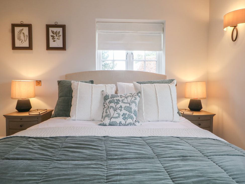 A bedroom with a bed and bedside lamps at Sea Estate House in Littlehampton
