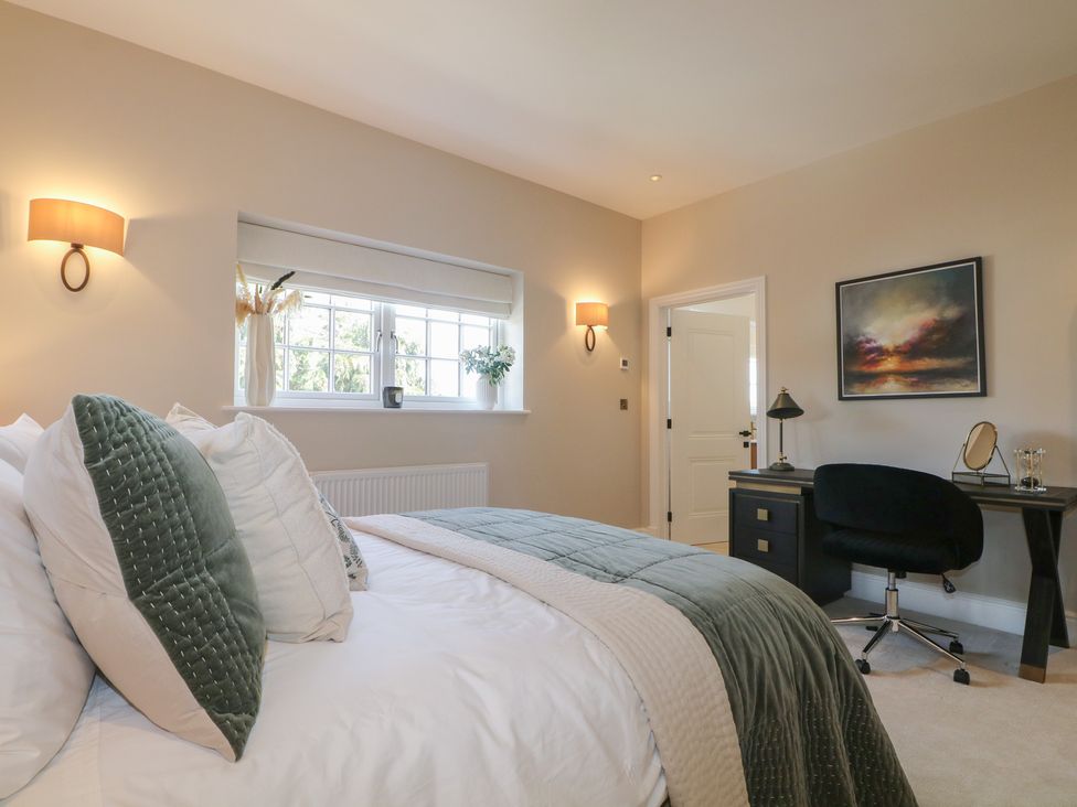 A bedroom with a bed and desk at Sea Estate House in Littlehampton