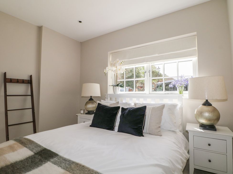 A bedroom with a bed and bedside tables at Sea Estate House in Littlehampton