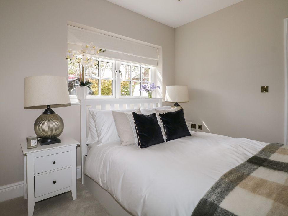 A bedroom with a bed and a lamp at Sea Estate House in Littlehampton