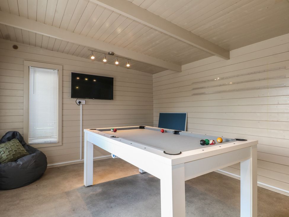 A game room with a pool table and television at Sea Estate House in Littlehampton