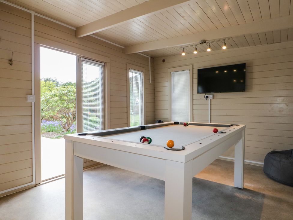 A game room with a pool table and television at Sea Estate House in Littlehampton