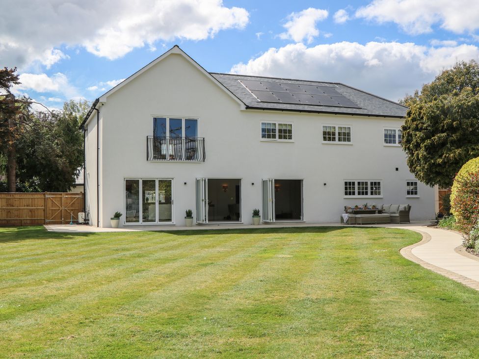 A house with a garden and patio at Sea Estate House in Littlehampton