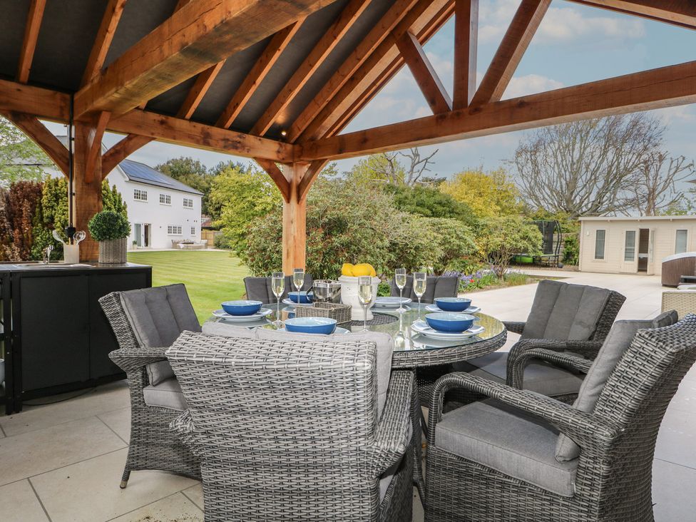 An outdoor dining area with a table and chairs at Sea Estate House in Littlehampton