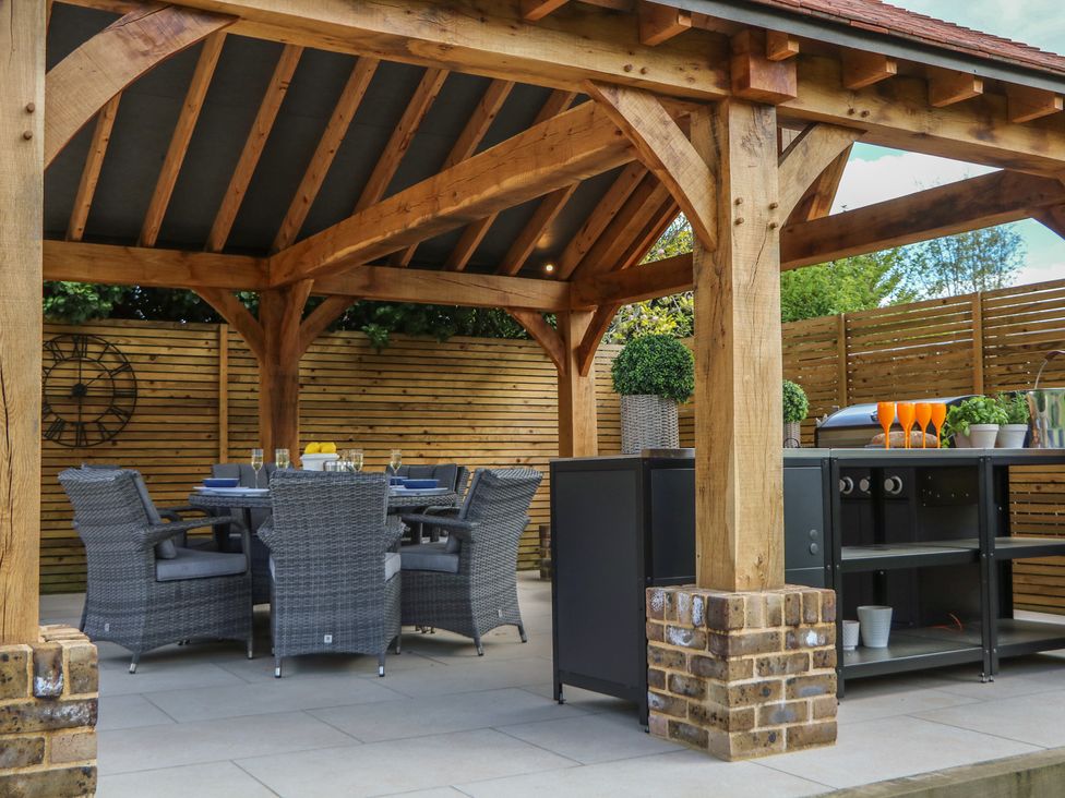 An outdoor dining area with table and chairs at Sea Estate House in Littlehampton