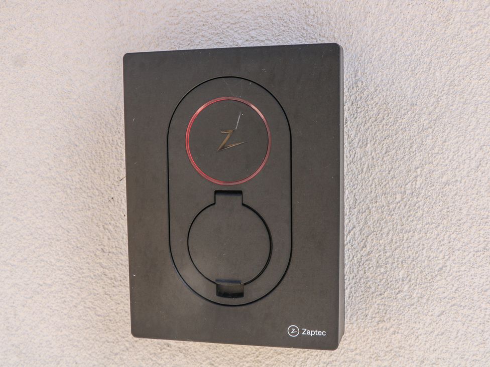 A Zaptec electric vehicle charging station mounted on a wall at Sea Estate House in Littlehampton