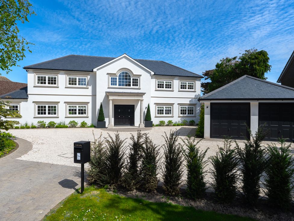 A house with a garage and pathway at Sea Estate House in Rustington