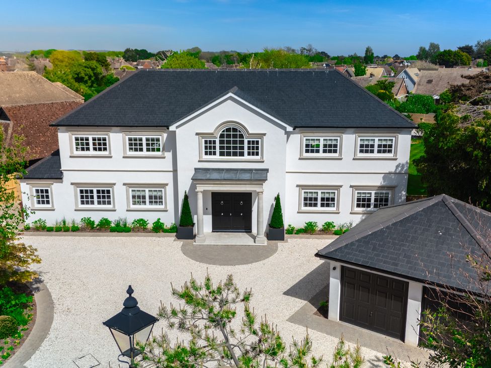A house with a garage and driveway at Sea Estate House Rustington