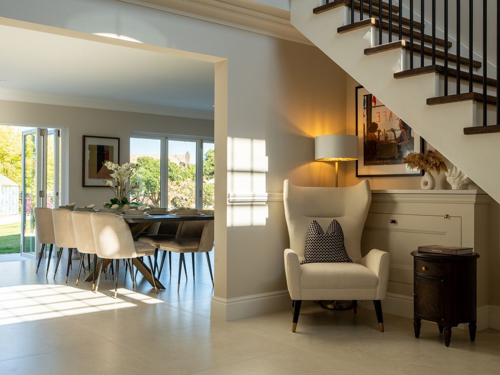 A dining room with a table and chairs at Sea Estate House Rustington