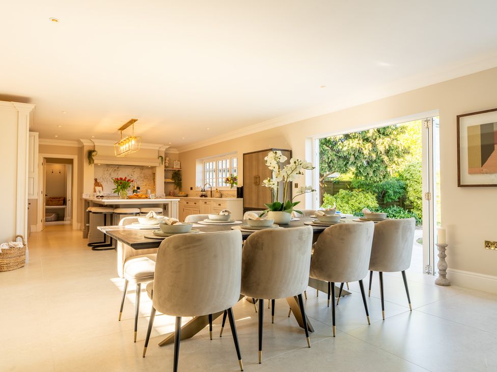 A kitchen with a dining table and chairs at Sea Estate House in Rustington