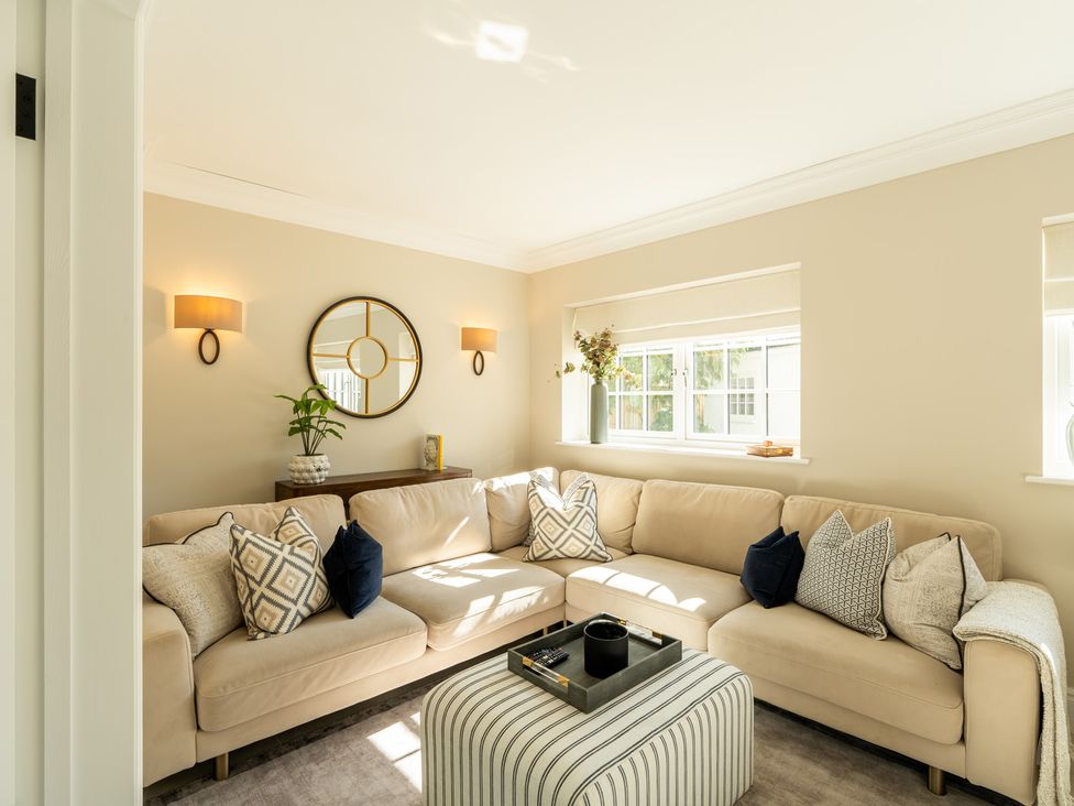 A living room with a sofa and a coffee table at Sea Estate House Rustington