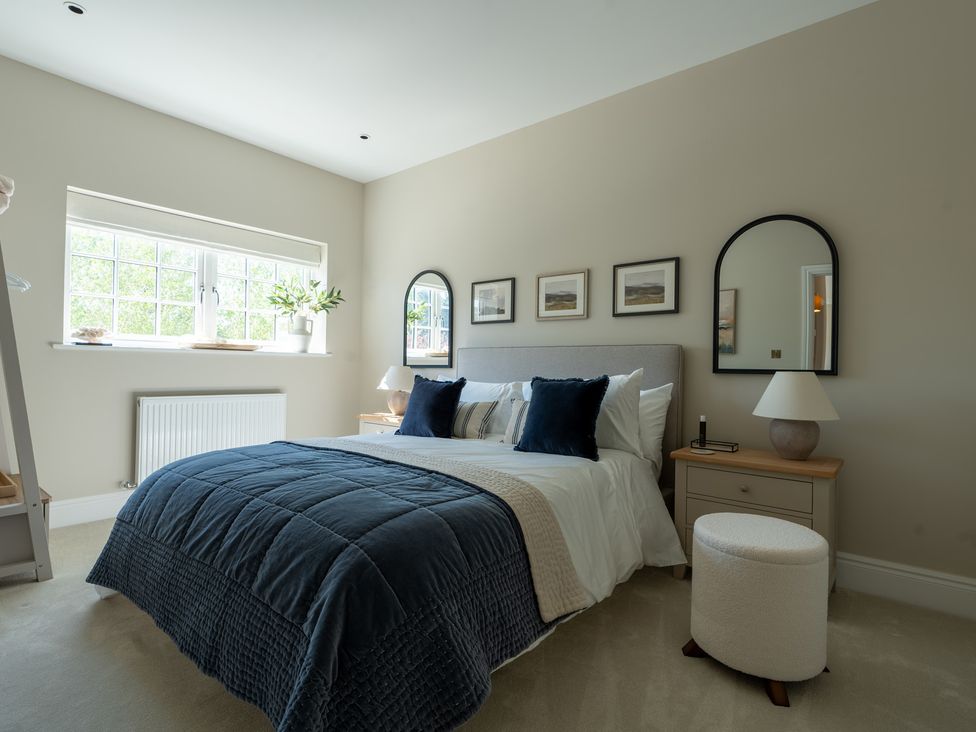 A bedroom with a bed and bedside table at Sea Estate House in Rustington