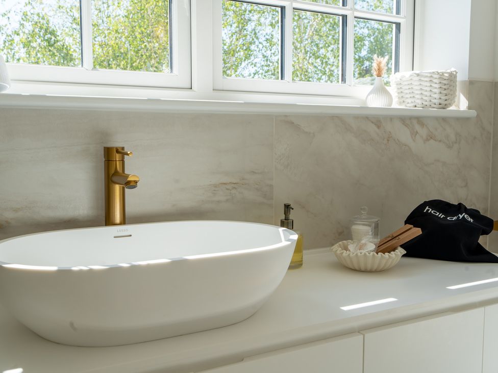 A bathroom with a sink and faucet at Sea Estate House in Rustington