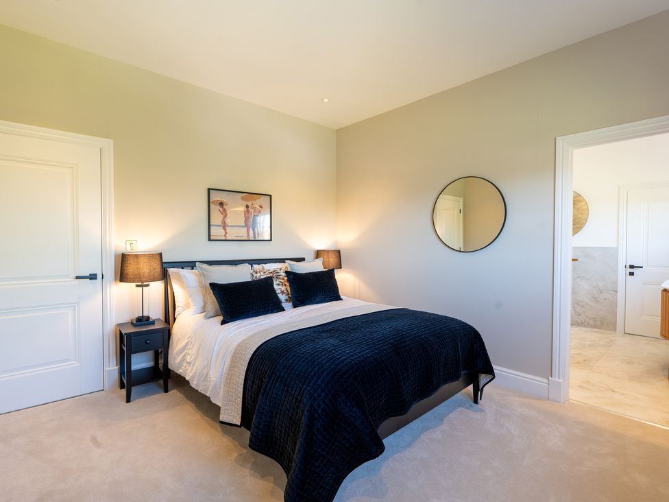 A bedroom with a bed and bedside tables at Sea Estate House in Rustington