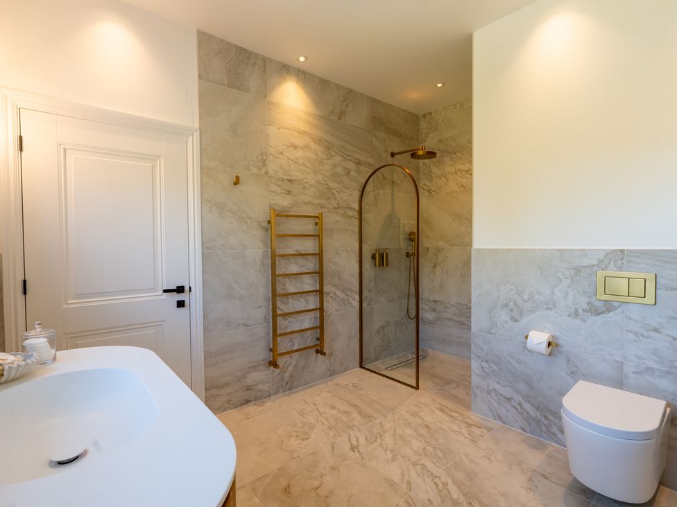 A bathroom with towel rack and shower at Sea Estate House in Rustington