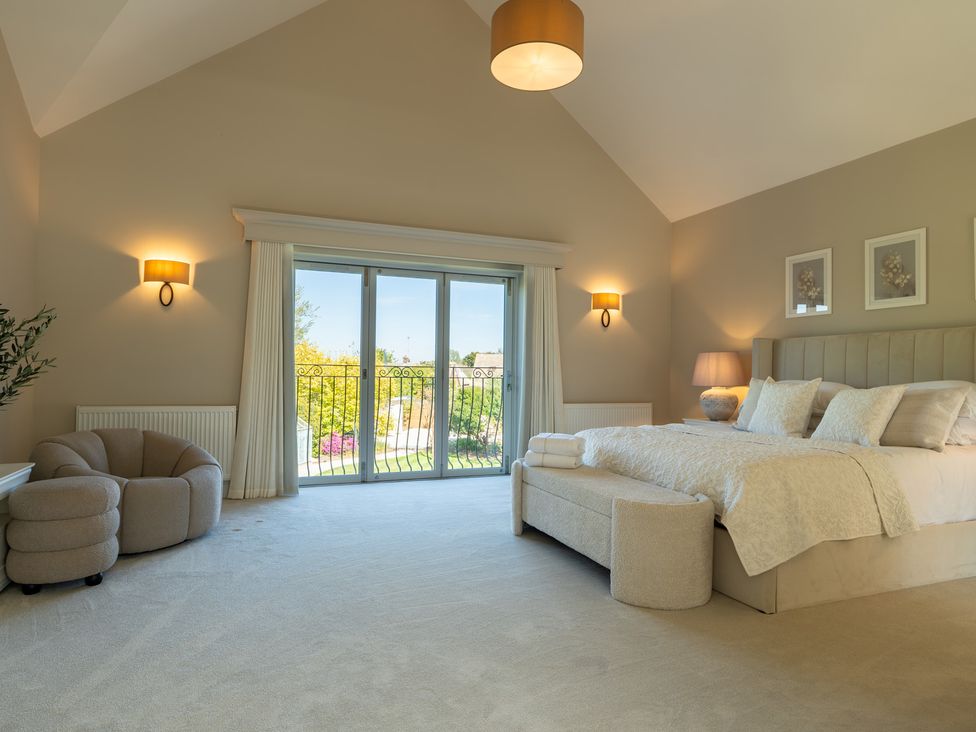 A bedroom with a bed and furniture at Sea Estate House in Rustington